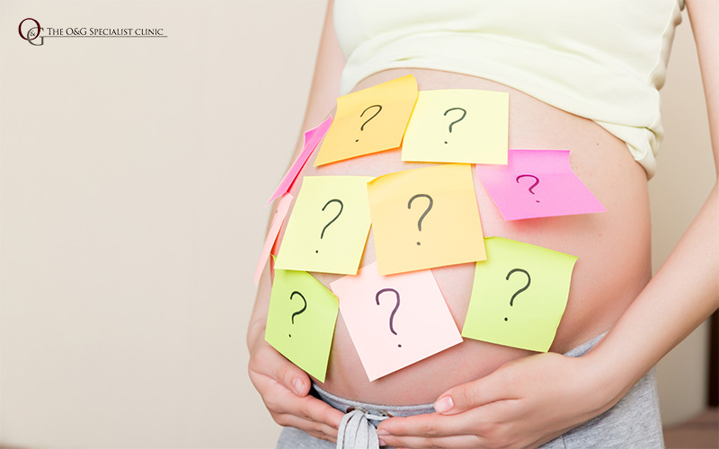 A baby bump with sticky notes attached to it.
