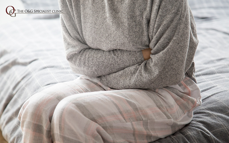 Woman experiencing period pain or cramps.